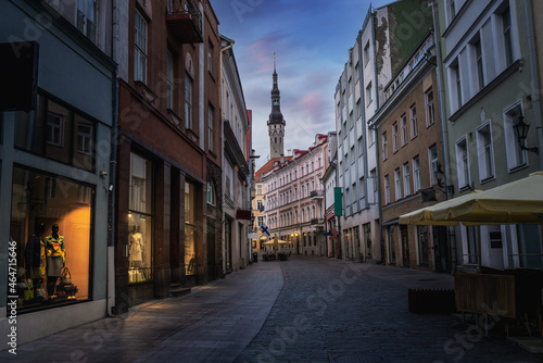 Tallinn old town Viru Street at sunset with Tallinn Town Hall Tower on background - Tallinn, Estonia