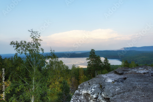 mountain view of Lake Arakul, Russia in the middle of the forest at dusk photo