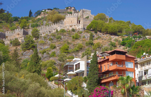 Turkey. Antalya. 09.15.21. View of the resort town on the Mediterranean coast. Houses on the slopes of the mountains and an old fortress wall. photo