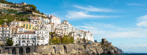 Italian coastline with city in mountain.