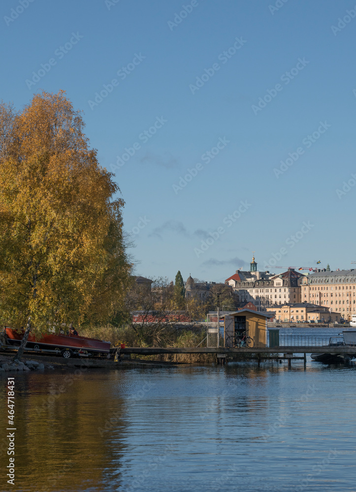 Piers with boats at the islands in the Stockholm harbor a colorful autumn day