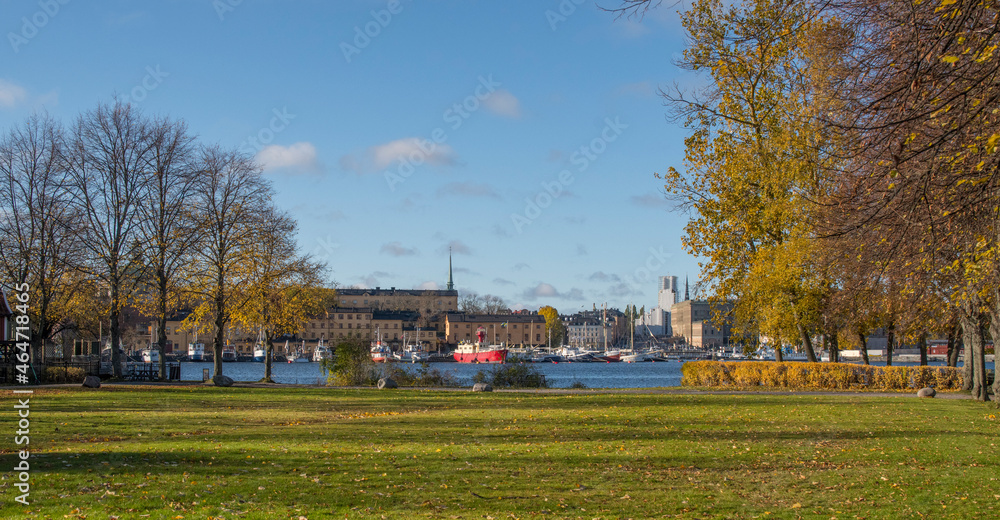 Piers with boats at the islands in the Stockholm harbor a colorful autumn day