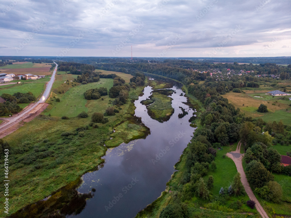 Areal drone view of river and overcast sky.
