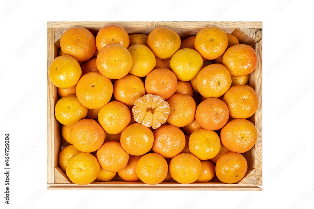 overhead view of a wooden box with many tangerines and peeled segments, isolated on white background.