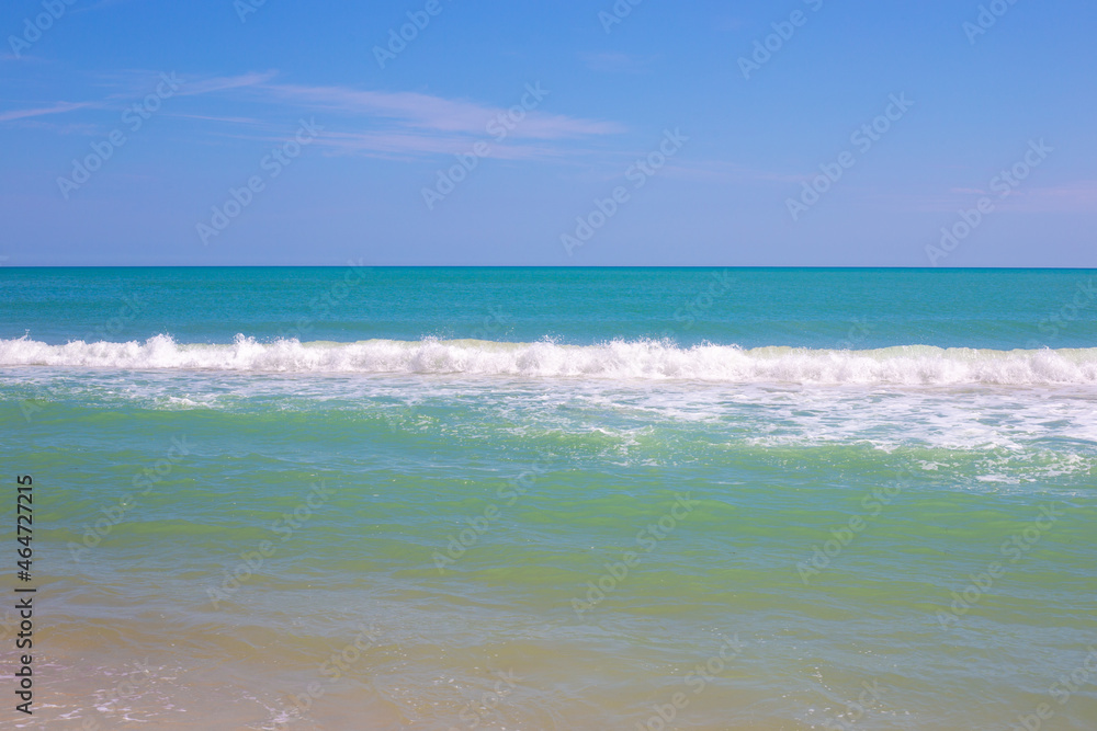 Blue sea with foamy wave and blue sky. Travel and tourism. Beautiful seascape