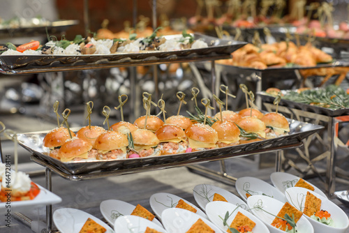 Fototapeta Naklejka Na Ścianę i Meble -  A set of canapes and snack at a banquet with white table. Slices of tomato, olive, cheese, bread and fish on food stand