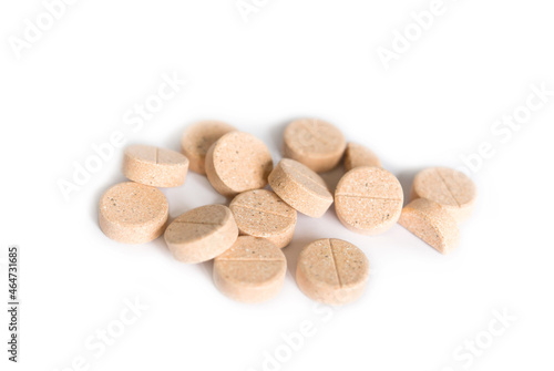 Natural plant pills on a white background. Round herbal tablets close-up. Healthcare and medicine. Homeopathy and Alternative Medicine 