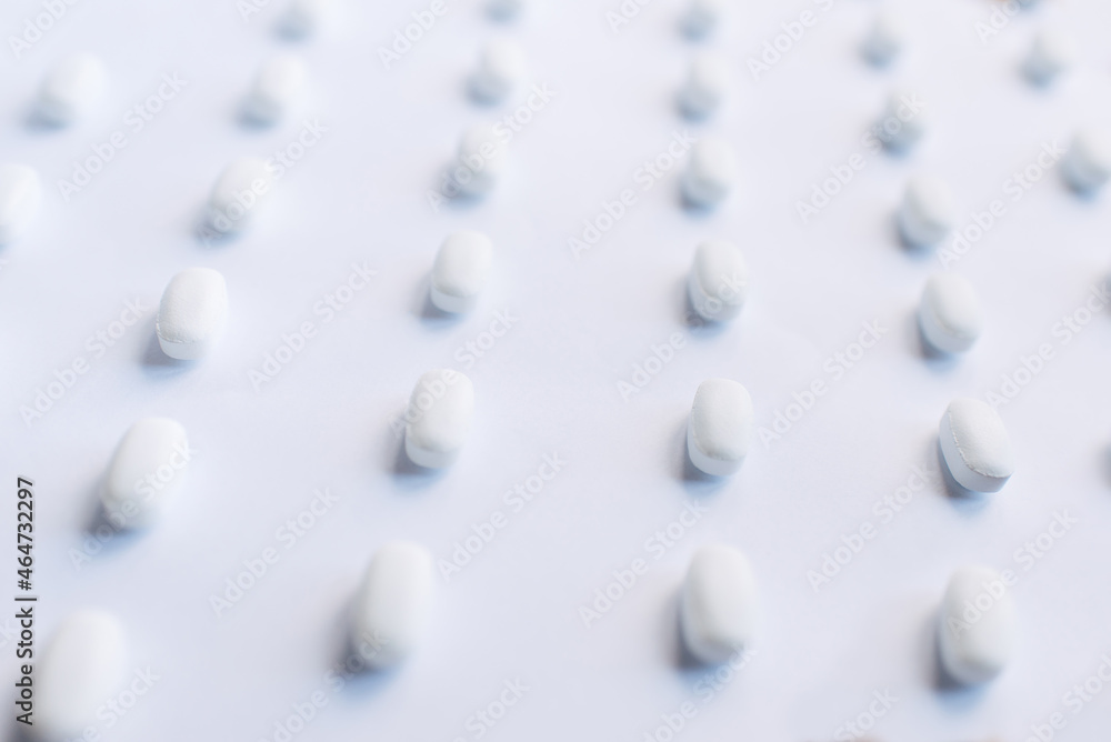 Many white pills on a white background. Health. Many white pills on a white background. Health.