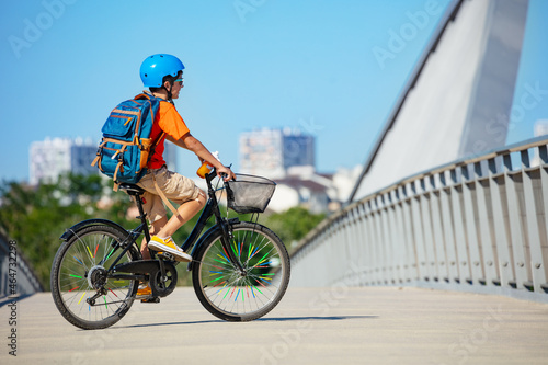 Side view of the school child boy ride a bicycle