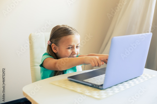 Little cute girl uses laptop to have video call
