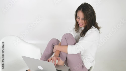 Woman doing work using laptop. Girl working remotely indoors