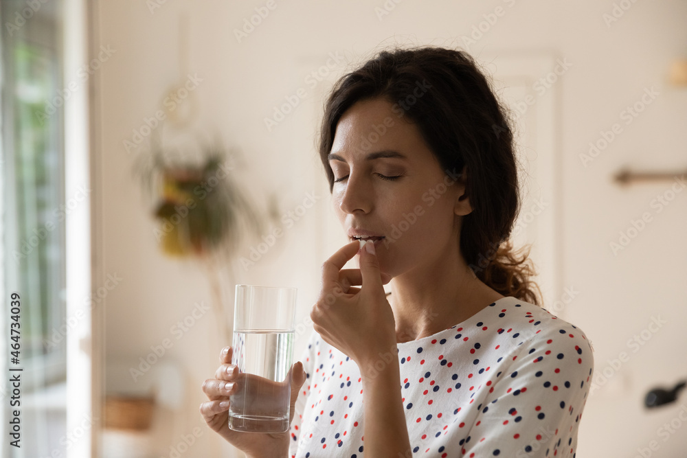 Stressed tired woman taking vitamins, painkillers, antidepressants, pills, meds against headache, insomnia, nervous disorder, anxiety. Patient with medication fighting against flu infection, migraine Stressed tired woman taking vitamins, painkillers, antidepressants, pills, meds against headache, insomnia, nervous disorder, anxiety. Patient with medication fighting against flu infection, migraine