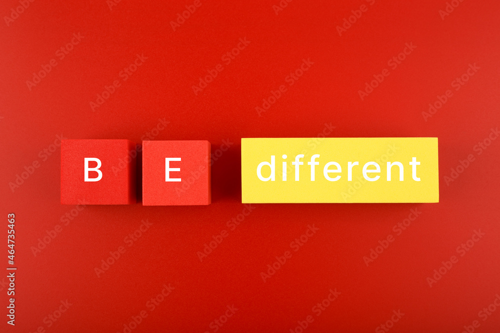 Concept of individuality, brainstorming, fresh ideas and being different from others on red background Concept of individuality, brainstorming, fresh ideas and being different from others on red background