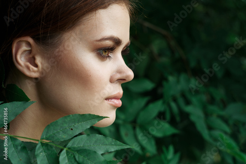 portrait of a woman Cosmetology nature green leaves glamor close-up