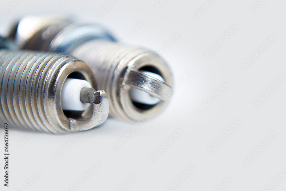 spark plugs on white background with copy space and reflection. auto spare parts on white background spark plugs on white background with copy space and reflection. auto spare parts on white background
