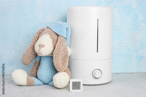 Air humidifier and electronic hygrometer. Knitted toy dog. Humidity in the children's room. Close up photo