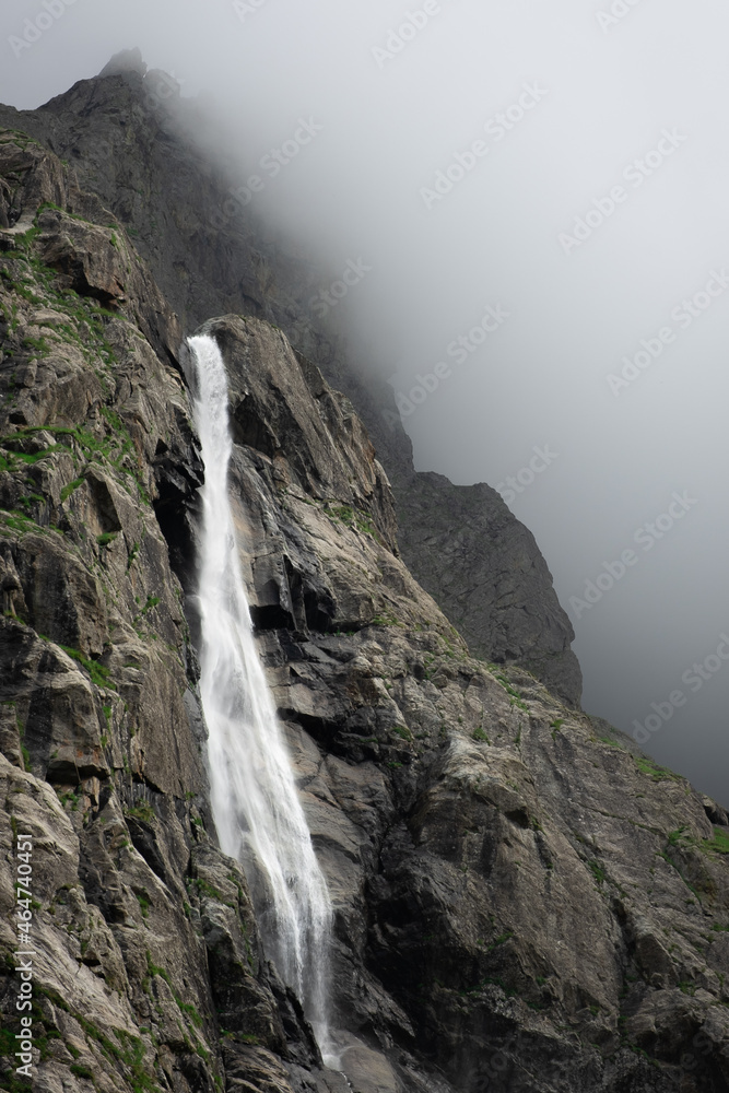 Obraz premium Beautiful view of Midagrabin waterfall in sunlight in cloudy summer weather. Caucasus mountains. Russia. North Ossetia Alania