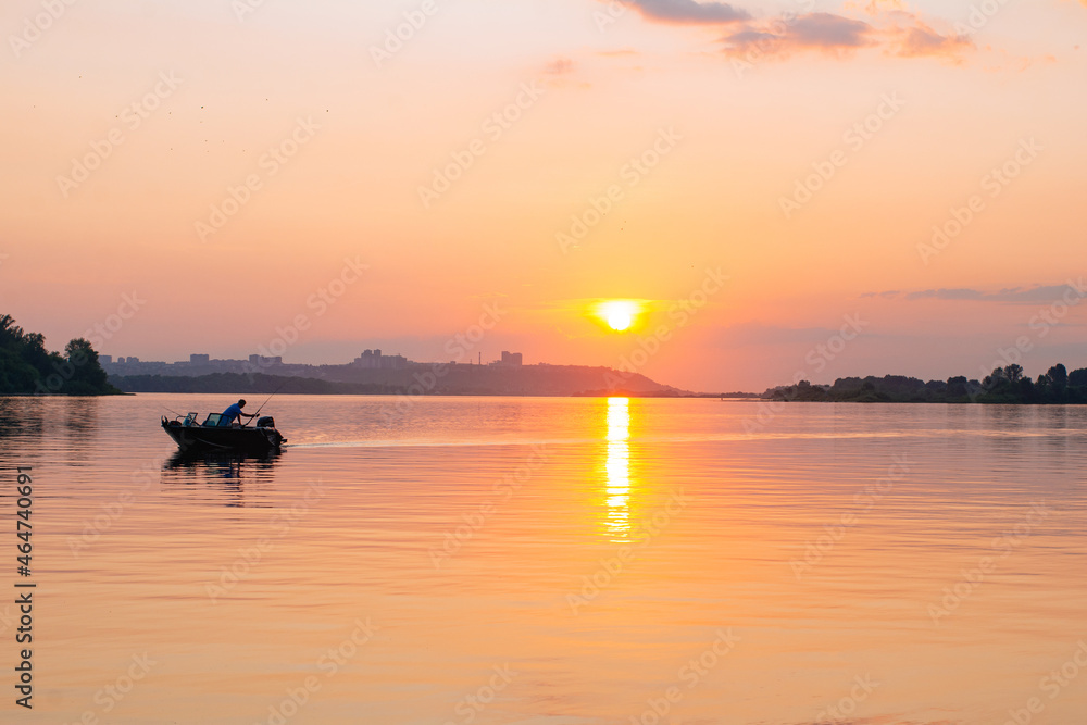 Calm water surface with boat and pink sunset sky. Meditation water and yellow sky background. Horizon over the water.