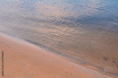 river surface and sand beach. water surface. water background. blue and sunny water surface. abstract blue water