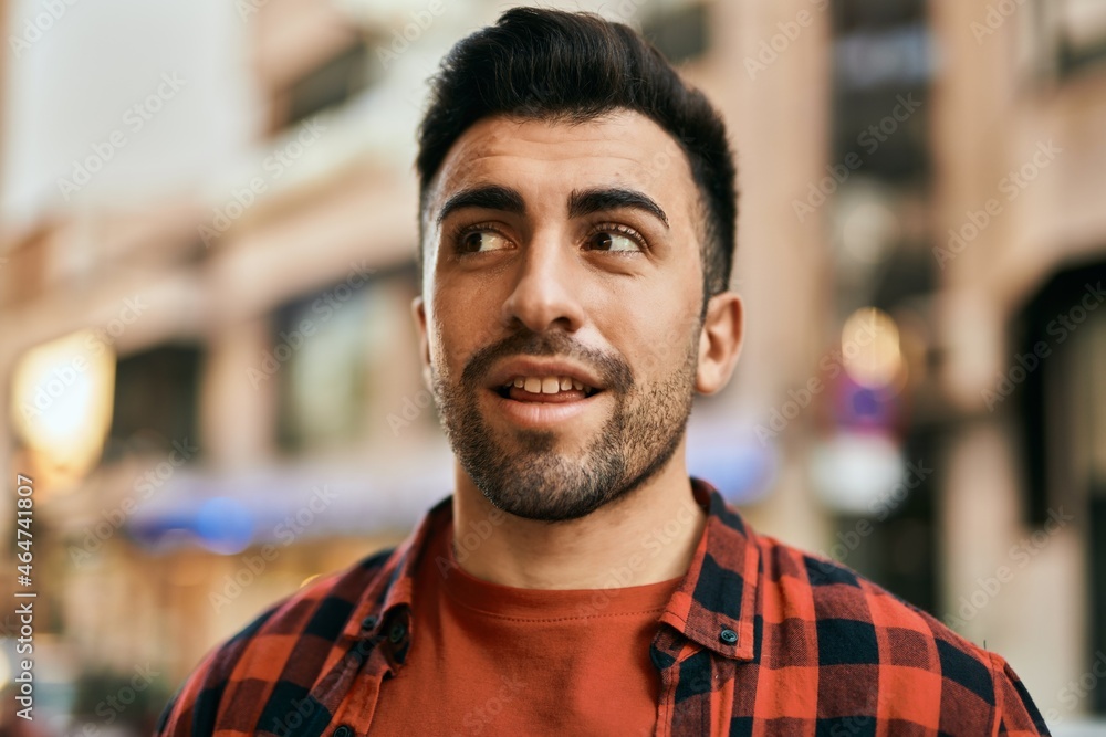Young hispanic man smiling happy standing at the city. Young hispanic man smiling happy standing at the city.