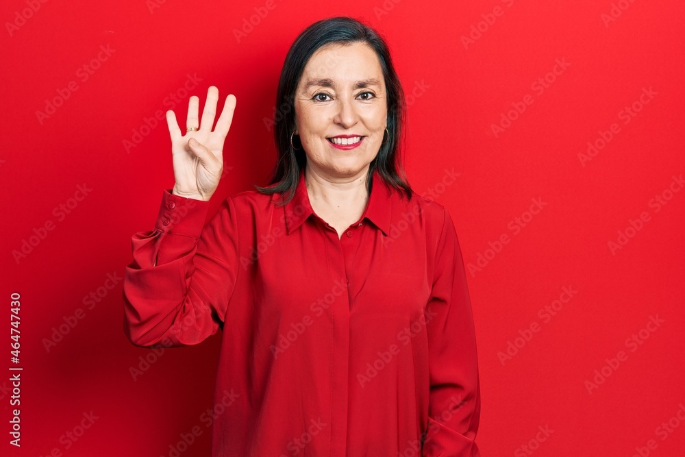 Middle age hispanic woman wearing casual clothes showing and pointing up with fingers number four while smiling confident and happy. Middle age hispanic woman wearing casual clothes showing and pointing up with fingers number four while smiling confident and happy.
