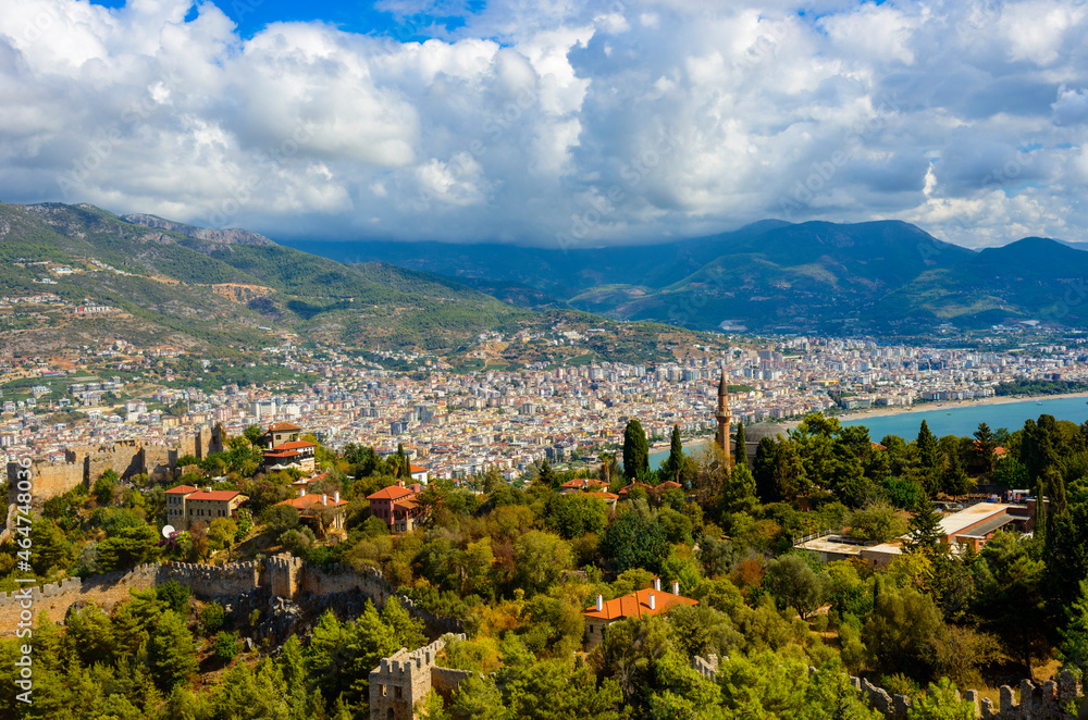
sunny view of Alanya against the backdrop of mountains and with beautiful clouds

