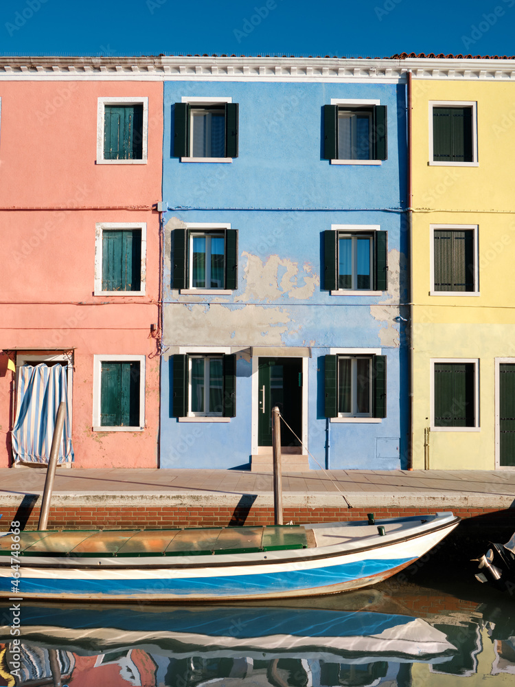 Colorful houses by canal in Burano island, Italy. Historic italian architecture in historic village not far from Venice.