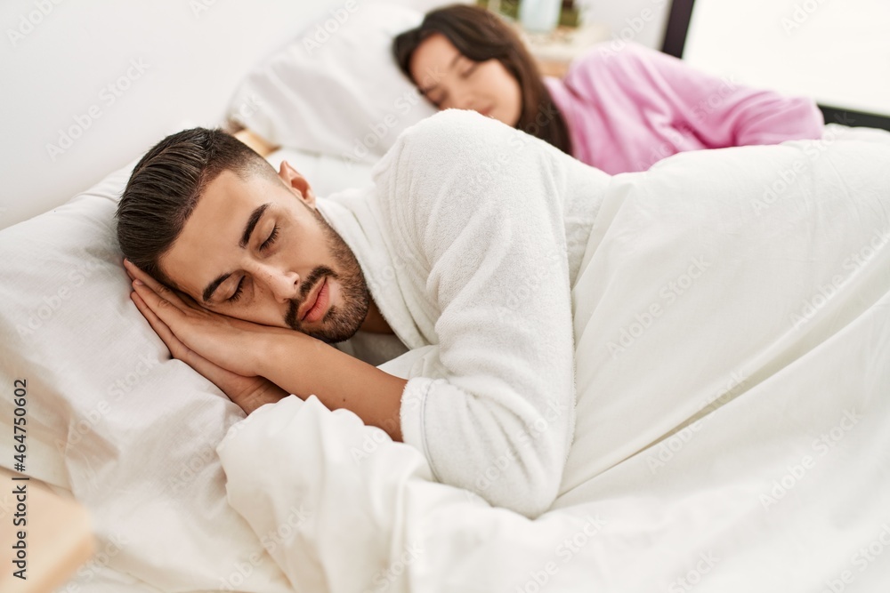 Young hispanic couple sleeping on bed at home. Young hispanic couple sleeping on bed at home.