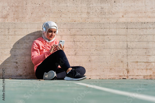 Muslim young woman with headphones taking a break