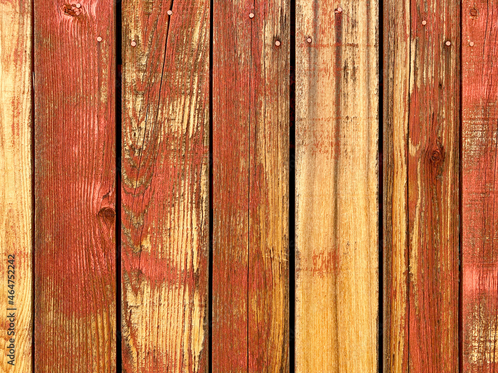 Fototapeta premium red yellow orange painted fading weathered backyard garden fence wood boards architectural background