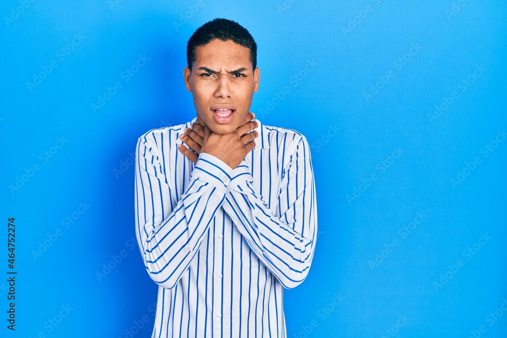 Young african american guy wearing casual clothes shouting and suffocate because painful strangle. health problem. asphyxiate and suicide concept. Young african american guy wearing casual clothes shouting and suffocate because painful strangle. health problem. asphyxiate and suicide concept.