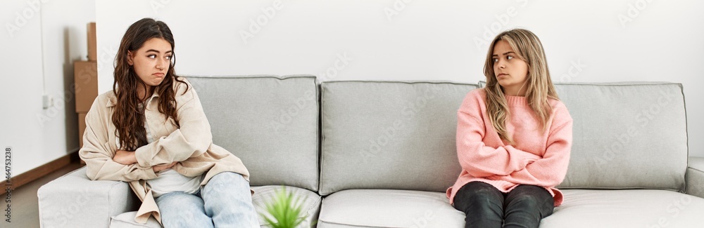 Young couple angry sitting on the sofa in silence at home. Young couple angry sitting on the sofa in silence at home.
