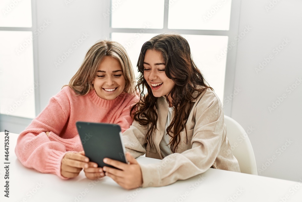 Young couple smiling happy using touchpad at home. Young couple smiling happy using touchpad at home.