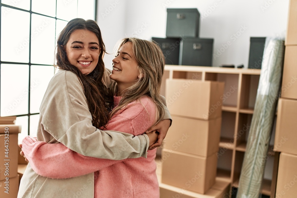 Young couple smiling happy and hugging at new home. Young couple smiling happy and hugging at new home.