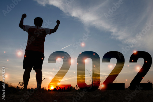 Happy new year Silhouette sunset background.A man standing next to 2022.new year,success,2022, Photo Silhouette and new year concept idea.