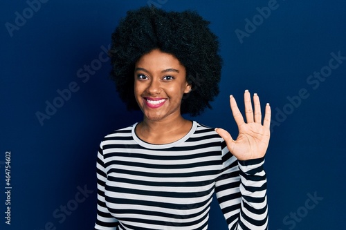 Young african american woman wearing casual clothes showing and pointing up with fingers number five while smiling confident and happy.