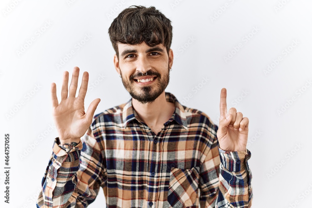 Hispanic man with beard standing over isolated background showing and pointing up with fingers number six while smiling confident and happy. Hispanic man with beard standing over isolated background showing and pointing up with fingers number six while smiling confident and happy.