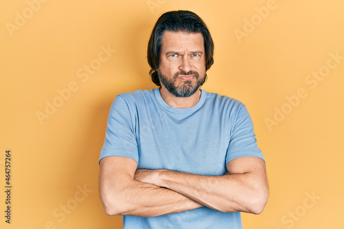 Middle age caucasian man wearing casual clothes skeptic and nervous, disapproving expression on face with crossed arms. negative person.