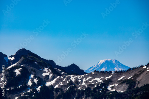 snow capped Mt. Baker under a blue clear sky as viewed from Paradise, Mt.Rainier National Park in Washington state.