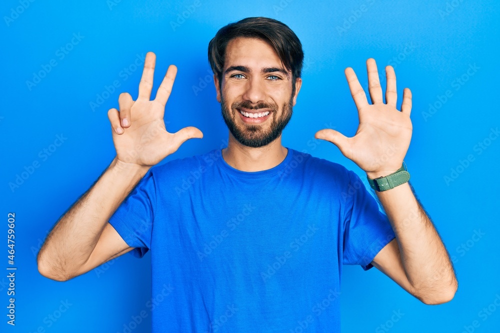 Young hispanic man wearing casual clothes showing and pointing up with fingers number eight while smiling confident and happy. Young hispanic man wearing casual clothes showing and pointing up with fingers number eight while smiling confident and happy.