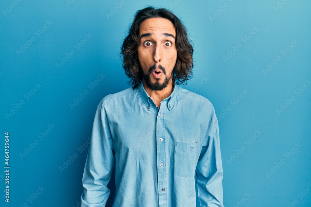 Young hispanic man wearing casual clothes afraid and shocked with surprise expression, fear and excited face. Young hispanic man wearing casual clothes afraid and shocked with surprise expression, fear and excited face.