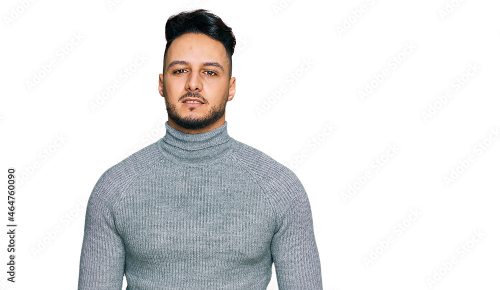 Young arab man wearing casual clothes relaxed with serious expression on face. simple and natural looking at the camera. Young arab man wearing casual clothes relaxed with serious expression on face. simple and natural looking at the camera.