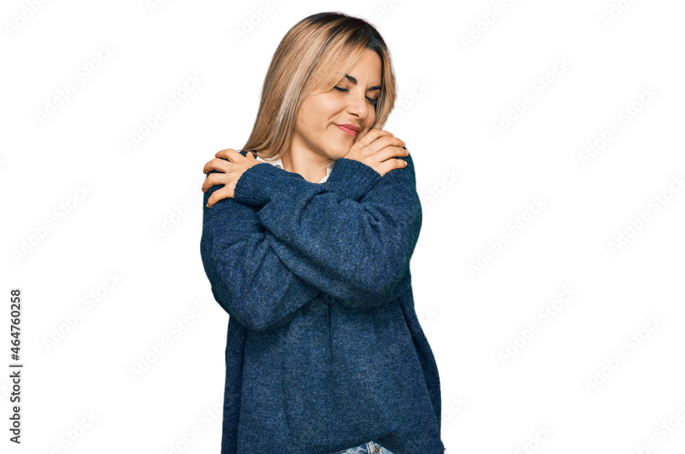 Young caucasian woman wearing casual clothes hugging oneself happy and positive, smiling confident. self love and self care Young caucasian woman wearing casual clothes hugging oneself happy and positive, smiling confident. self love and self care