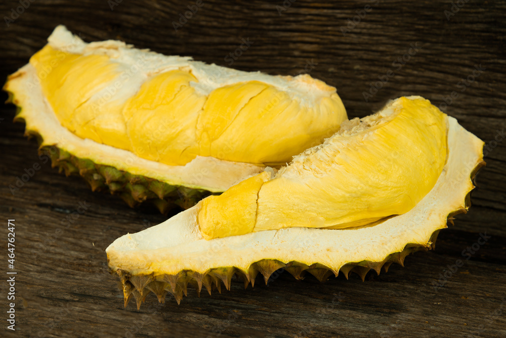 Group of Durian with unshelled seeing the durian with golden ripe meat on wooden background. Durian is the king of fruit and the most famous fruit in Thailand. Group of Durian with unshelled seeing the durian with golden ripe meat on wooden background. Durian is the king of fruit and the most famous fruit in Thailand.