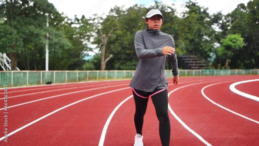 Tired female runner taking a rest after running hard on stadium track. Workout Healthy lifestyle concept. Tired female runner taking a rest after running hard on stadium track. Workout Healthy lifestyle concept.