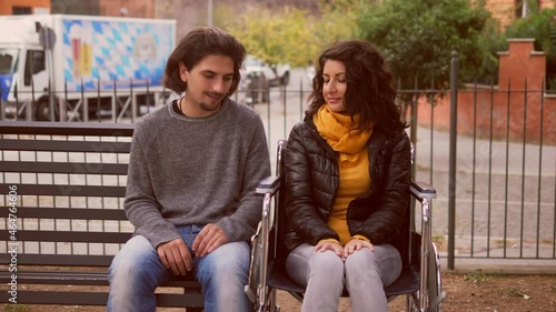 embarrassement, awkwardness - young shy man and his friend with paraplegia look each other shyly