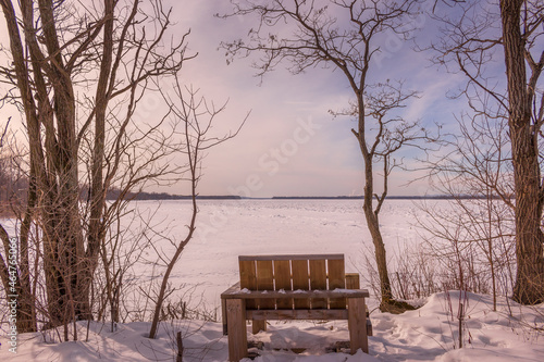 Wooden chair by the frozen Ottawa riverside © Catherine