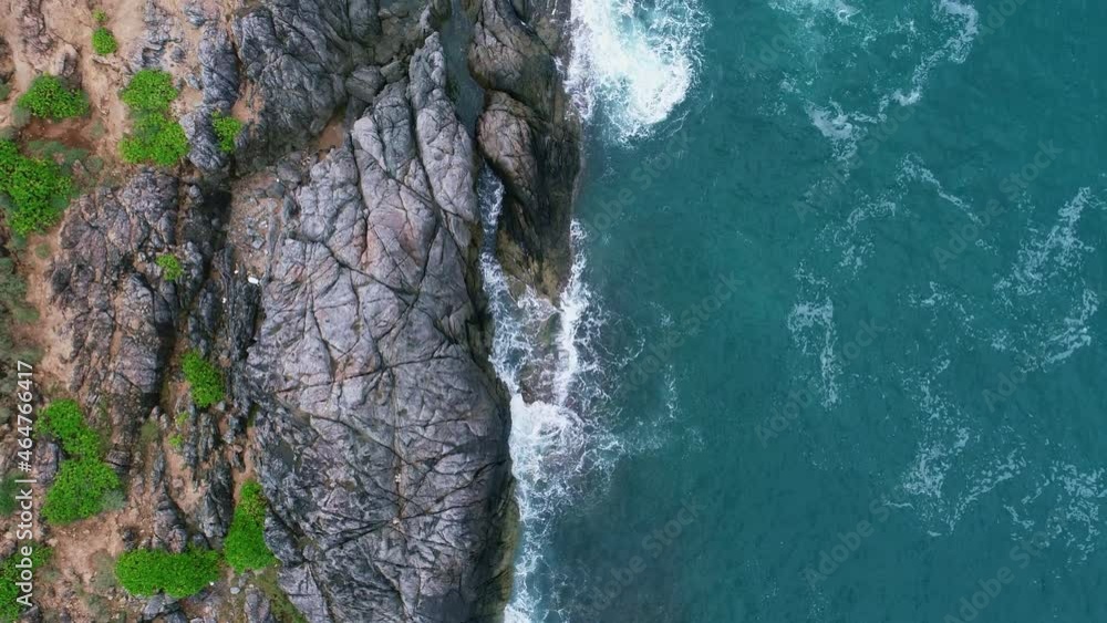 Aerial view Drone camera top down of seashore rocks in a blue ocean Turquoise sea surface Amazing sea waves crashing on rocks seascape Aerial view drone 4k High quality of ocean with stone rock cliff Aerial view Drone camera top down of seashore rocks in a blue ocean Turquoise sea surface Amazing sea waves crashing on rocks seascape Aerial view drone 4k High quality of ocean with stone rock cliff