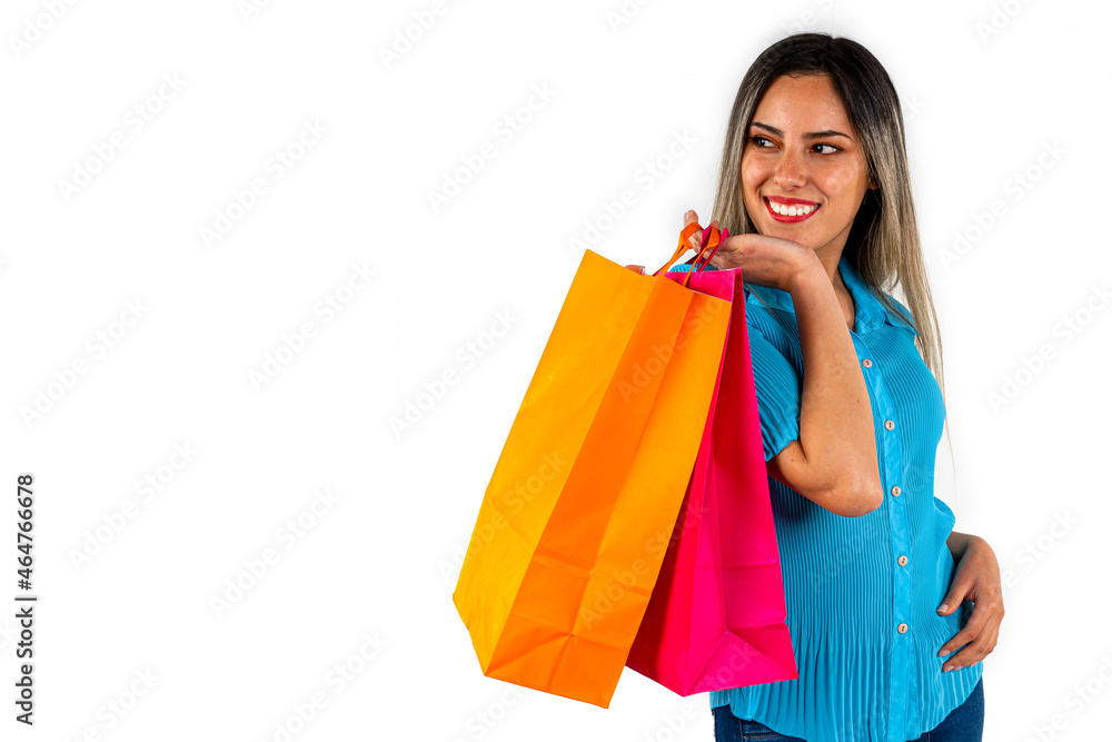 Beautiful young woman looking into empty space, with happy expression and colorful shopping bags in both hands. Copy space. White background. Beautiful young woman looking into empty space, with happy expression and colorful shopping bags in both hands. Copy space. White background.