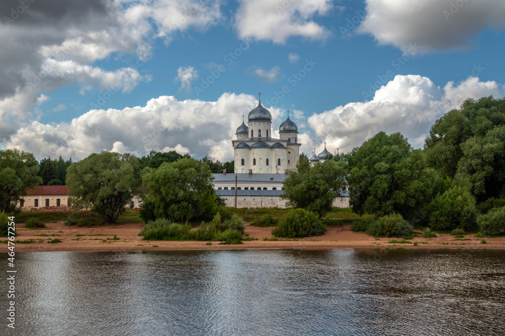 View of the St. George's Cathedral of the St. George (Yuriev) Monastery from the Volkhov River on a sunny summer day with cumulus clouds, Veliky Novgorod, Russia
